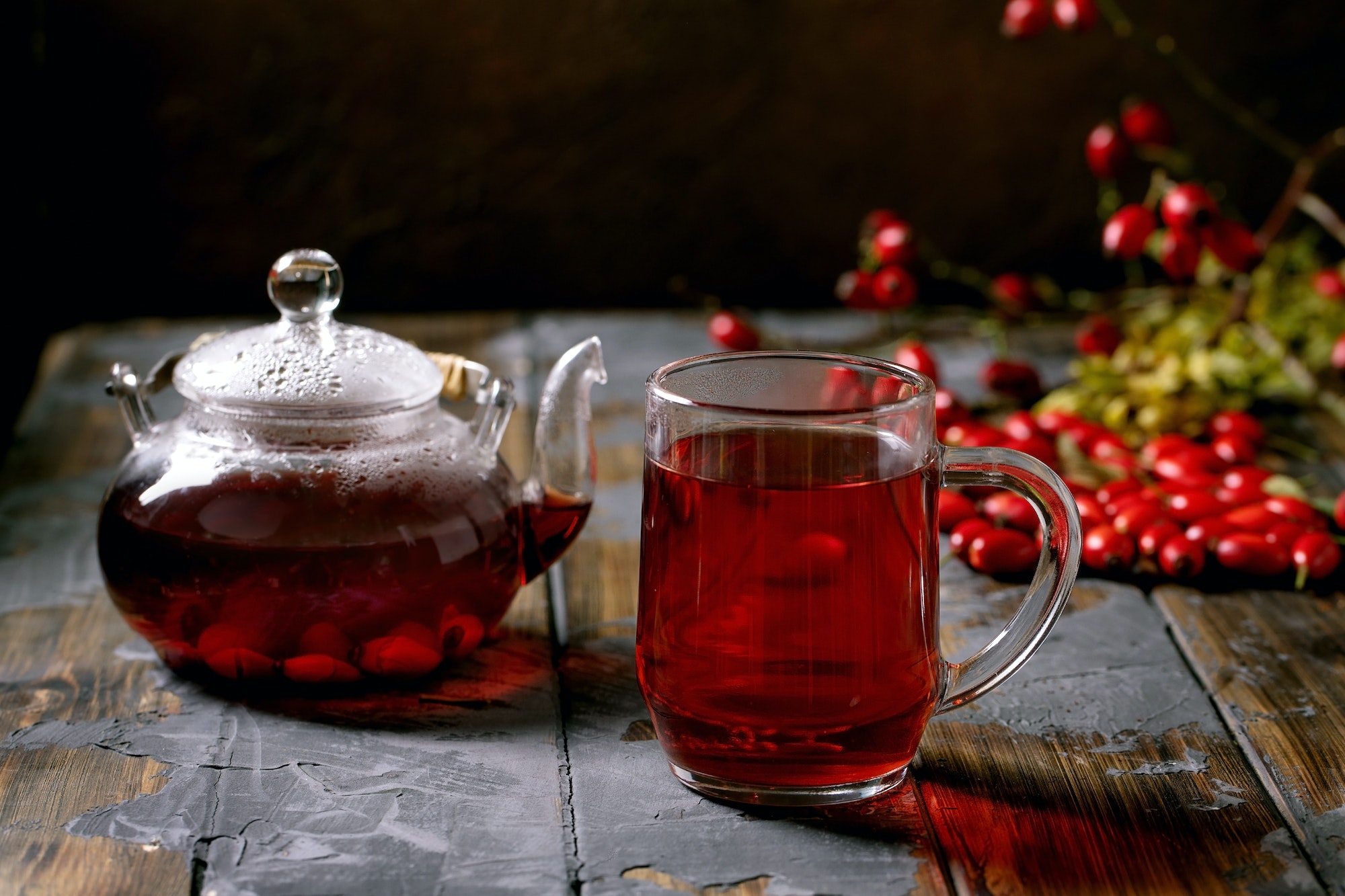Rose hip berries herbal tea in glass teapot